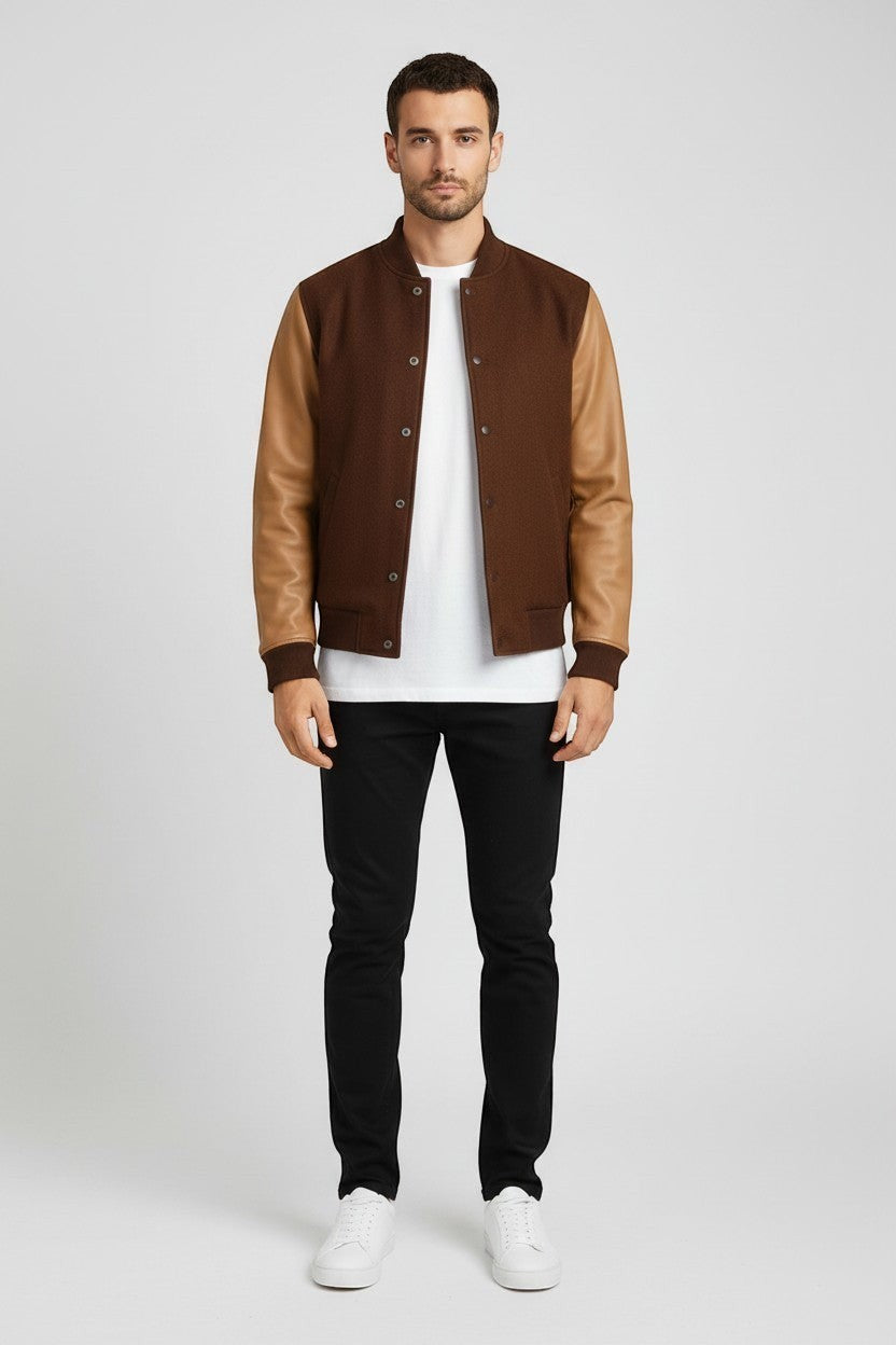 Scarlett Stitch Men's brown wool-blend varsity bomber jacket with tan leather sleeves, ribbed collar, cuffs, hem and snap closure.