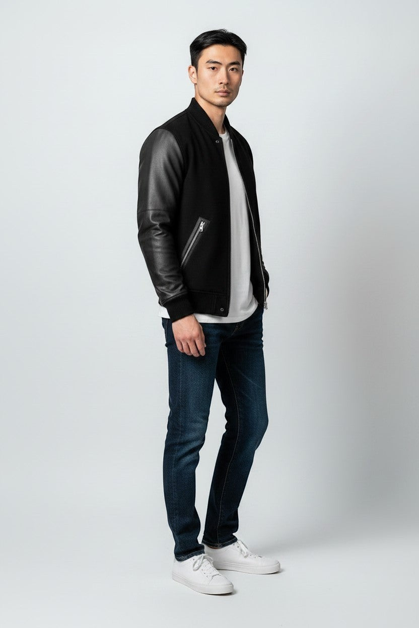 Scarlett Stitch Men's black bomber jacket with genuine leather sleeves, ribbed collar, cuffs, and hem.
