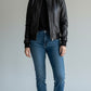 Scarlett Stitch women's black faux leather bomber jacket with ribbed collar, cuffs, and hem. Full zip front with side pockets.