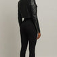 Scarlett Stitch black faux leather cropped moto jacket with diamond quilting and zippered cuffs.