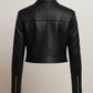 Scarlett Stitch black faux leather cropped moto jacket with diamond quilting on shoulders and zippered cuffs.