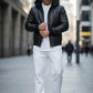 Scarlett Stitch black faux leather hooded bomber jacket with sherpa lining, ribbed cuffs and hem, worn by a man.
