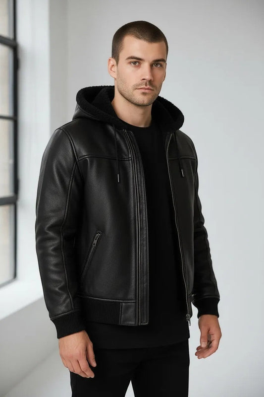 Scarlett Stitch Men's black faux leather bomber jacket with sherpa-lined hood, zip front, and ribbed cuffs.