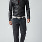 Scarlett Stitch Men's black faux leather moto jacket with stand-up collar, epaulets, chest pockets, and zippered cuffs.