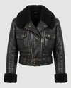 Scarlett Stitch black faux leather cropped moto jacket with faux shearling collar and cuffs, asymmetrical zip, and buckle belt.
