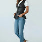 Scarlett Stitch black faux leather peplum vest with notched lapel and single-button closure, worn by a model with jeans.