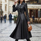 Scarlett Stitch black faux leather belted full skirt trench coat with wide lapels and a matching belt.