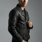 Scarlett Stitch black leather biker jacket with contrast stitching, metal zippers, and waist belt on a male model.