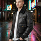 Scarlett Stitch black leather bomber jacket with faux fur collar, ribbed cuffs, and multiple pockets. Worn by a man in a city at night.