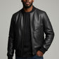 Scarlett Stitch men's black leather bomber jacket with ribbed collar, cuffs, and hem. Full zip front, side pockets.