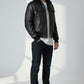 Scarlett Stitch black leather bomber jacket with detachable faux-shearling collar, utility sleeve pocket, and ribbed trim