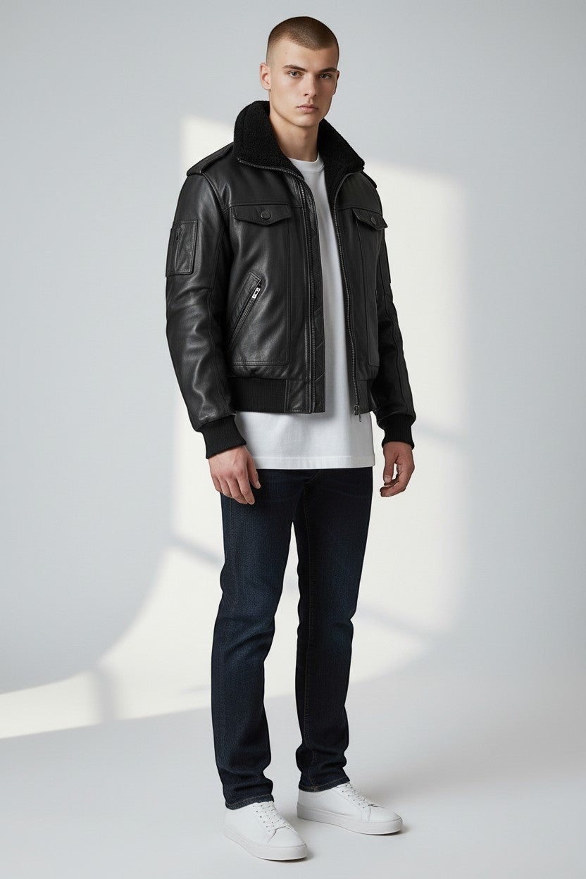 Model wearing a Scarlett Stitch black leather bomber jacket with a faux-shearling collar, utility pocket, and ribbed trim