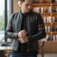 Scarlett Stitch men's black leather racer jacket with red sleeve stripes, stand-up collar, and zippered cuffs.