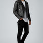Scarlett Stitch black leather biker jacket with silver stud sleeves, asymmetrical zip, and belted waist on a model.
