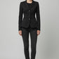 Scarlett Stitch women's black tailored blazer with notched lapel and three-button closure, paired with dark wash jeans.