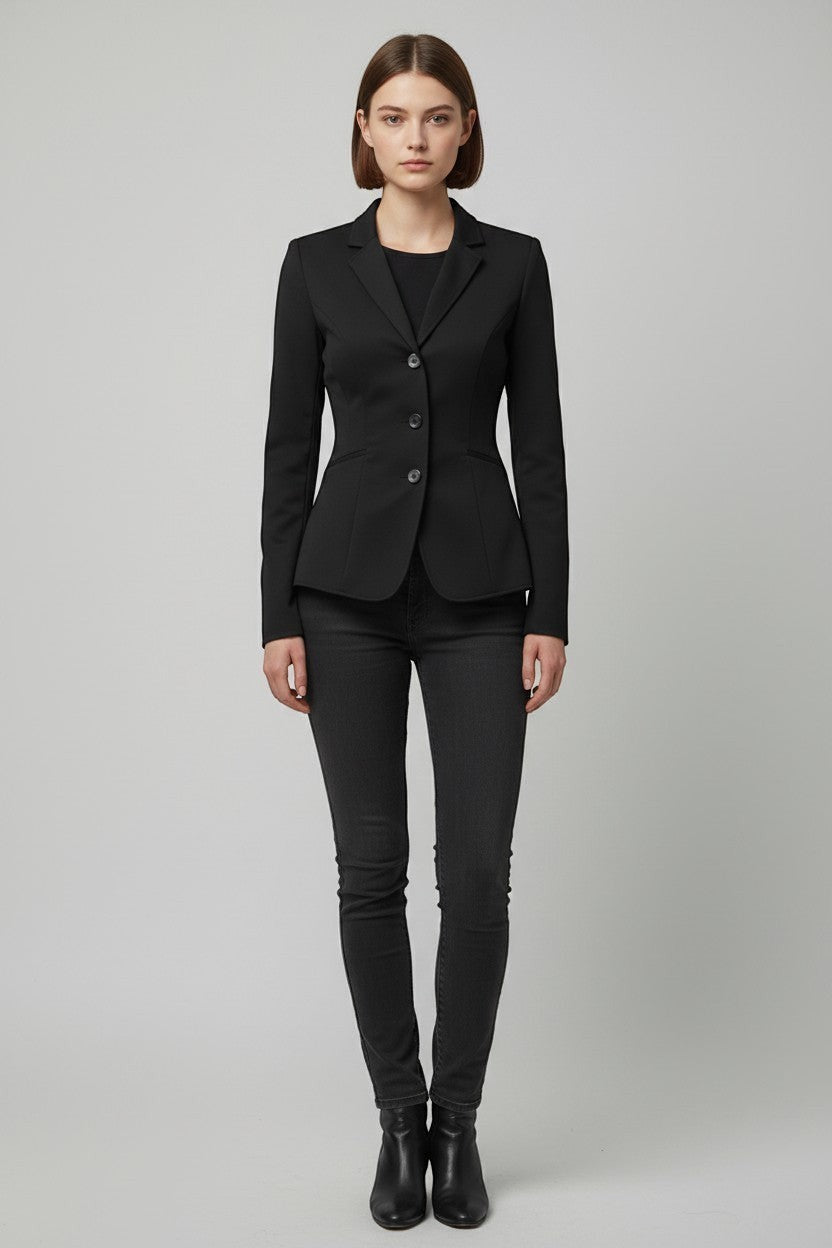 Scarlett Stitch women's black tailored blazer with notched lapel and three-button closure, paired with dark wash jeans.