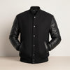 Scarlett Stitch Men's black wool-blend varsity jacket with genuine leather sleeves, snap front, and ribbed trim.