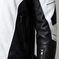 Scarlett Stitch black and white faux leather motorcycle jacket with quilted shoulder padding and zippered side pockets