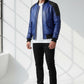 Scarlett Stitch men's royal blue leather bomber jacket with black accents and quilted detailing.
