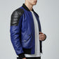 Scarlett Stitch Men's royal blue leather bomber jacket with black quilted shoulders and ribbed cuffs.
