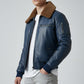 Scarlett Stitch men's blue leather bomber jacket with a brown faux-fur collar, ribbed cuffs, and zippered sleeve pocket.