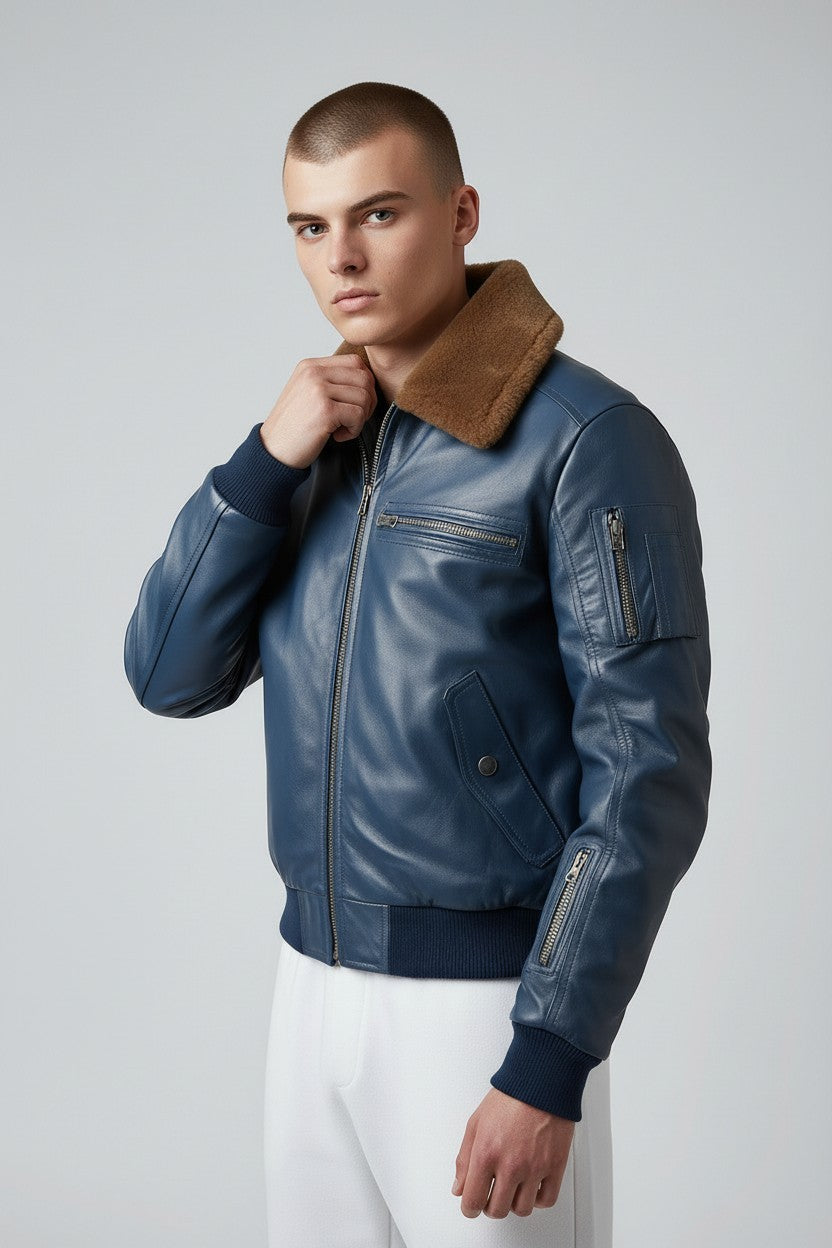 Scarlett Stitch men's blue leather bomber jacket with a brown faux-fur collar, ribbed cuffs, and zippered sleeve pocket.