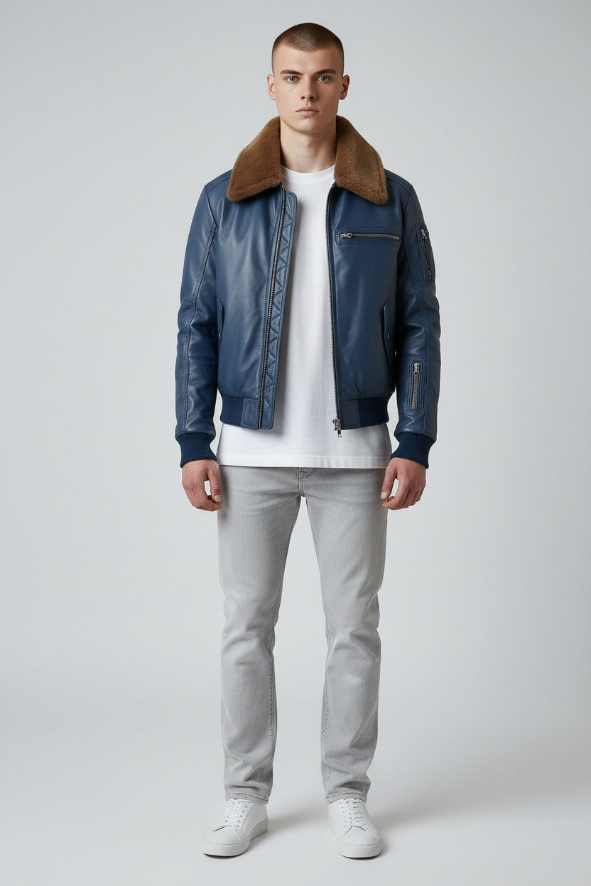 Scarlett Stitch men's blue leather bomber jacket with a brown faux-fur collar, ribbed cuffs, and metal zipper details.