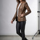 Scarlett Stitch brown distressed leather blazer with notched lapels and four-button closure on a model.