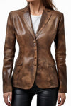 Scarlett Stitch brown distressed leather blazer with notched lapels and four-button front closure on a woman.