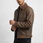 Scarlett Stitch men's brown distressed leather bomber jacket with a structured collar and front zipper.