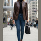 Scarlett Stitch brown faux leather collarless blazer jacket with button front, worn by a woman with blonde hair and blue jeans.
