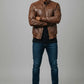 Scarlett Stitch men's brown faux leather bomber jacket with stand-up collar, zip front, and quilted shoulder panels.