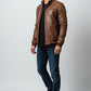 Scarlett Stitch brown faux leather bomber jacket with stand collar, zip front, ribbed cuffs and hem, and zippered pockets.