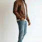Scarlett Stitch Men's brown faux leather bomber jacket with stand-up collar, zip front, and quilted shoulders.