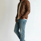 Scarlett Stitch Men's brown faux leather bomber jacket with stand-up collar, zip front, and quilted shoulder panels.