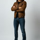 Scarlett Stitch Men's distressed brown faux leather bomber jacket with attached hood, ribbed cuffs, and zip pockets.