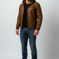 Scarlett Stitch Men's distressed brown faux leather bomber jacket with attached hood, ribbed cuffs, and zip pockets.