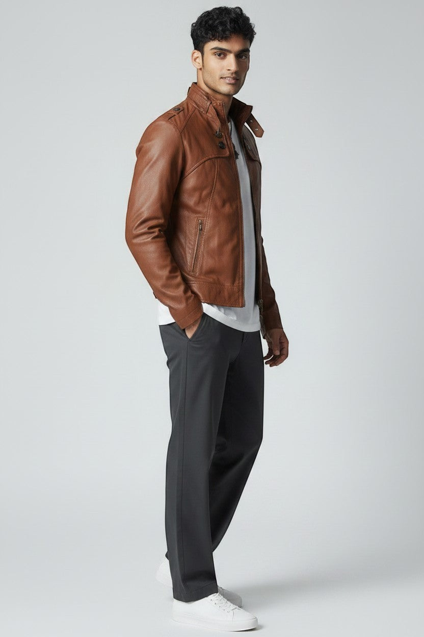 Scarlett Stitch brown faux leather jacket with stand collar worn by a model in a white t-shirt and grey trousers.