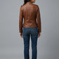 Scarlett Stitch brown faux leather moto jacket with zipper details, stand-up collar, and zippered cuffs.