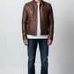 Man wearing a brown Scarlett Stitch faux leather utility jacket with chest pockets and a stand-up collar.