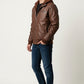Scarlett Stitch men's brown faux leather hooded jacket with ribbed cuffs and silver zippers worn by a male model