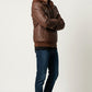 Scarlett Stitch men's brown faux leather hooded jacket with ribbed cuffs and silver zippers worn by a male model.