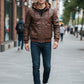 Scarlett Stitch men's brown faux leather hooded jacket with ribbed cuffs and silver zippers worn with jeans and sneakers