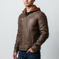 Scarlett Stitch men's brown leather jacket with a soft hooded insert, quilted shoulders, and silver-tone hardware.