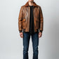 Scarlett Stitch Men's distressed brown faux leather bomber jacket with shearling collar, ribbed cuffs, and flap pockets.