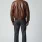 Scarlett Stitch Men's distressed brown leather bomber jacket with shirt collar, zippered front, and ribbed cuffs and hem.