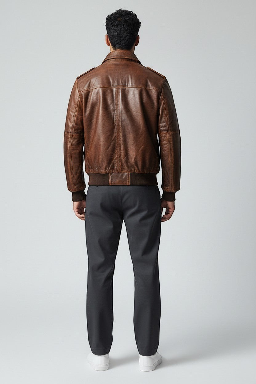 Scarlett Stitch Men's distressed brown leather bomber jacket with shirt collar, zippered front, and ribbed cuffs and hem.