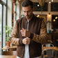 Scarlett Stitch Men's brown wool-blend bomber jacket with tan leather sleeves, ribbed collar, cuffs, and hem.