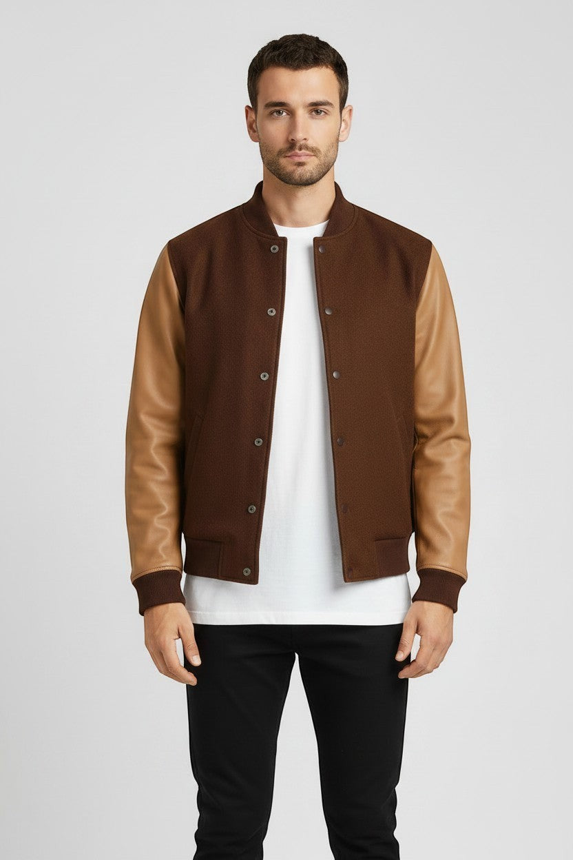 Scarlett Stitch Men's brown wool-blend varsity bomber jacket with tan leather sleeves, ribbed collar, cuffs, and hem.