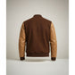 Scarlett Stitch Men's brown wool-blend varsity bomber jacket with tan leather sleeves and ribbed trim.